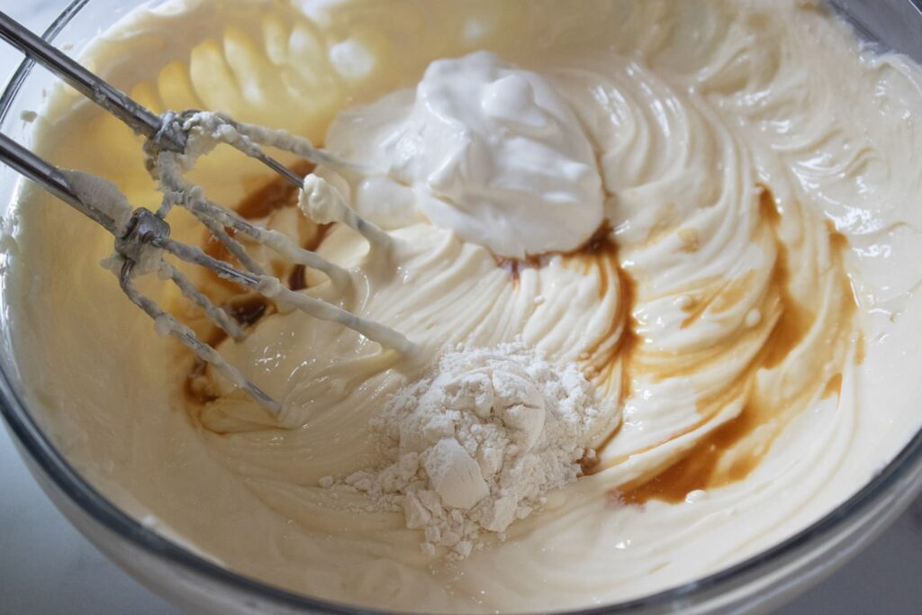 Adding flour, vanilla, and sour cream