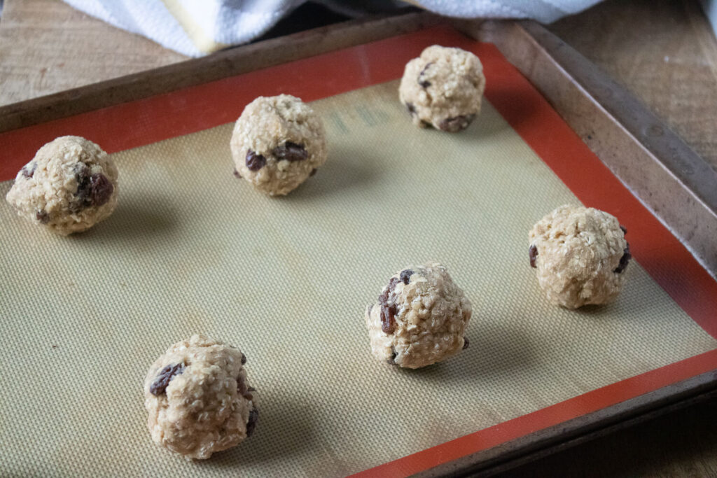 Rolling the dough into balls on a baking sheet