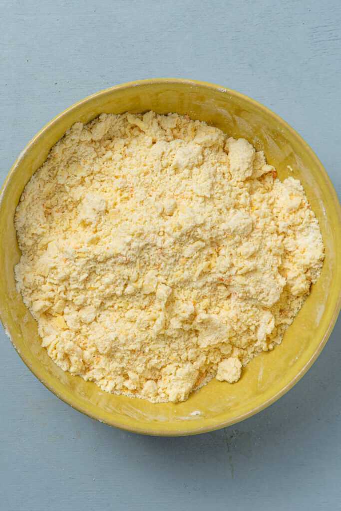 Mixing butter, flour, sugar, baking powder, salt, and orange zest