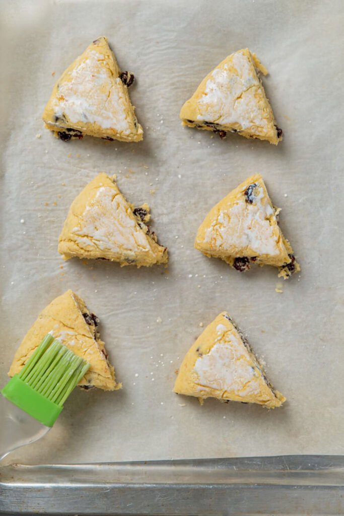 Brushing the scones with heavy cream