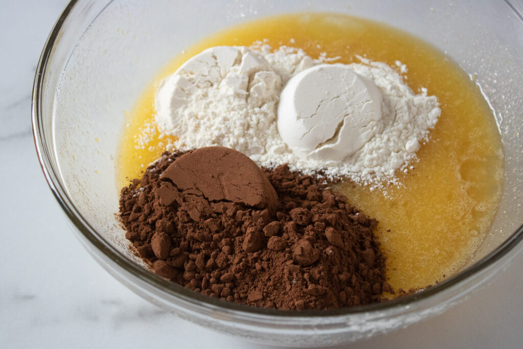 Adding flour, cocoa powder, and salt