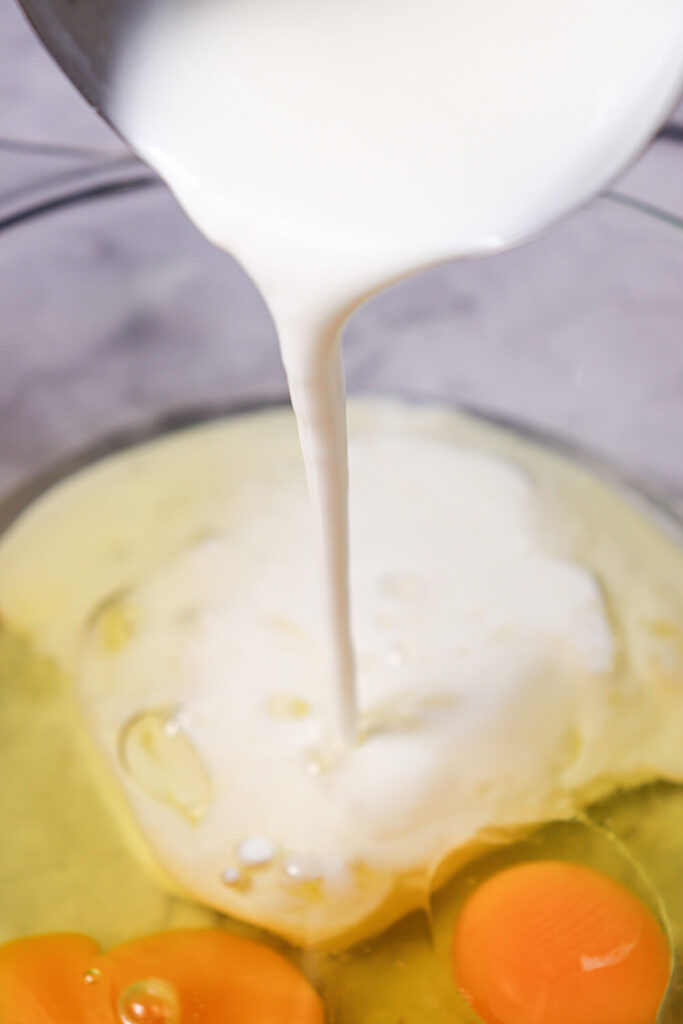Mixing buttermilk, eggs, oil, and vanilla extract