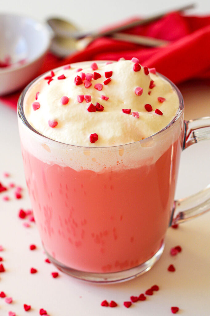 Serving the Red Velvet Hot Chocolate with red and pink sprinkles