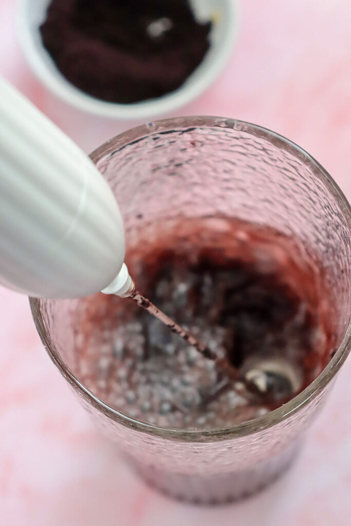 Mixing acai powder with coconut water