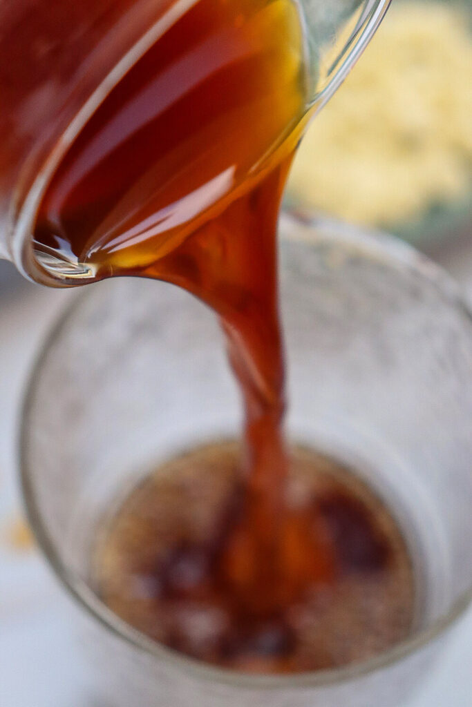 Filling a glass with ice cubes and coffee