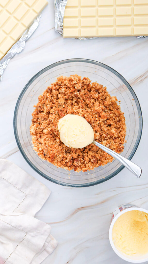 Mixing frosting into the crumbles